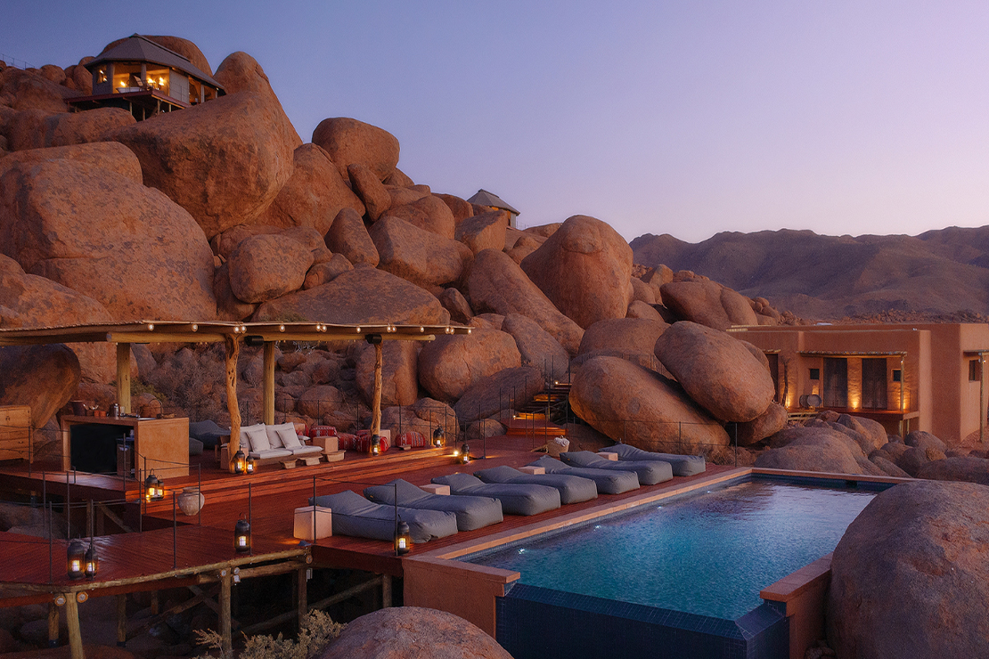 Desert lodge among granite boulders at dusk
